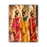 A vertical canvas art print depicting three Indian women from behind, wearing vibrant pink, yellow, and red sarees with gold borders and balancing brass pots on their heads in a sunlit courtyard.