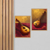 Two framed wall art prints depicting ornate stringed musical instruments in warm gold and red tones, displayed on a light wall beside vertical wood slats.