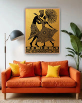 Tribal dancing couple wall art canvas displayed above an orange sofa in a modern living room
