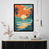A framed tropical beach sunset print hangs on a white wall above a black console table with books, a lamp, and dried grass in a vase. The artwork shows palm trees, turquoise waves, a yellow sun, and an orange sky.