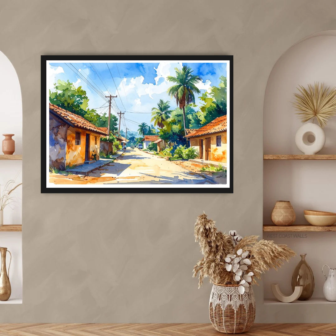 Framed tropical village painting on a wall with decorative vases and plants below.