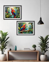 Two framed paintings of parrots on a wall with a console table and plants below.