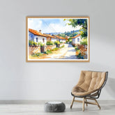 Framed painting of a village scene on a wall above a chair.