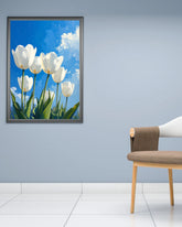 White tulip floral wall art canvas hanging on a blue wall in a minimalist interior
