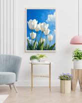 White tulip floral wall art canvas displayed in a bright modern interior with chair and plant
