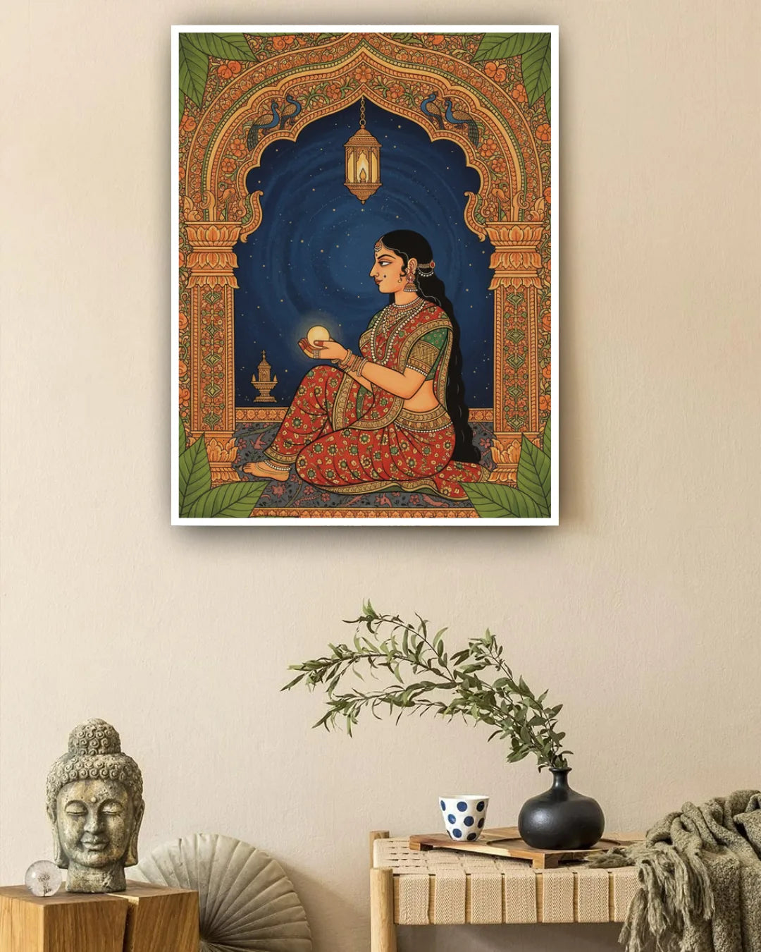 Framed artwork of a woman holding a light source, placed above a table with decorative items.