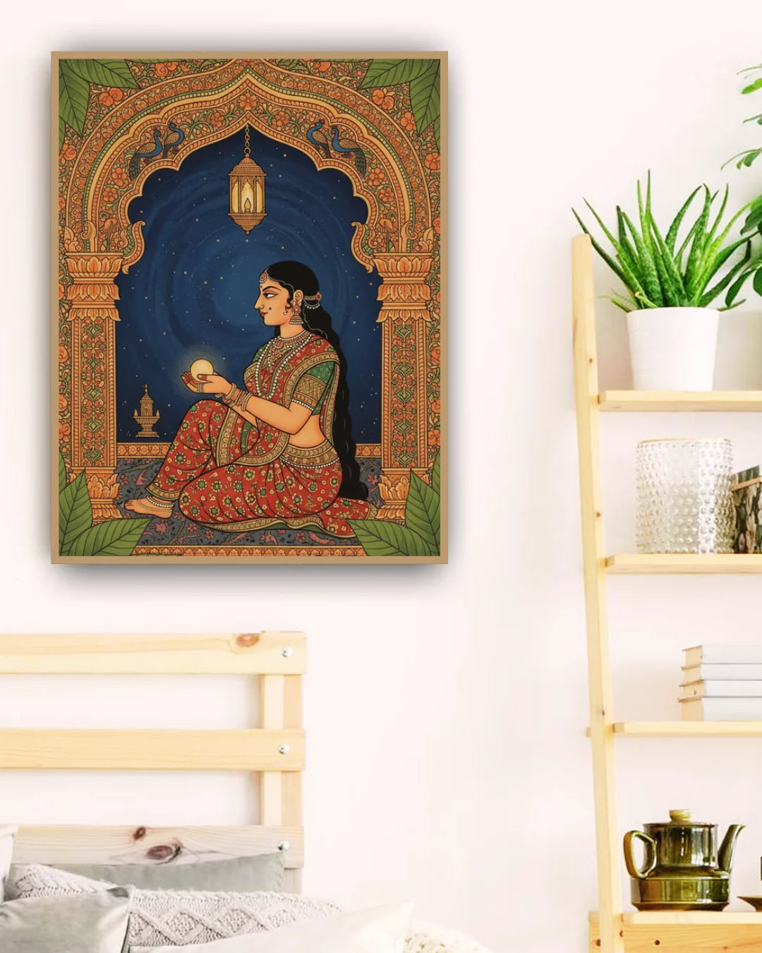 Decorative wall art of a woman in traditional attire in a colorful frame, placed on a white wall.