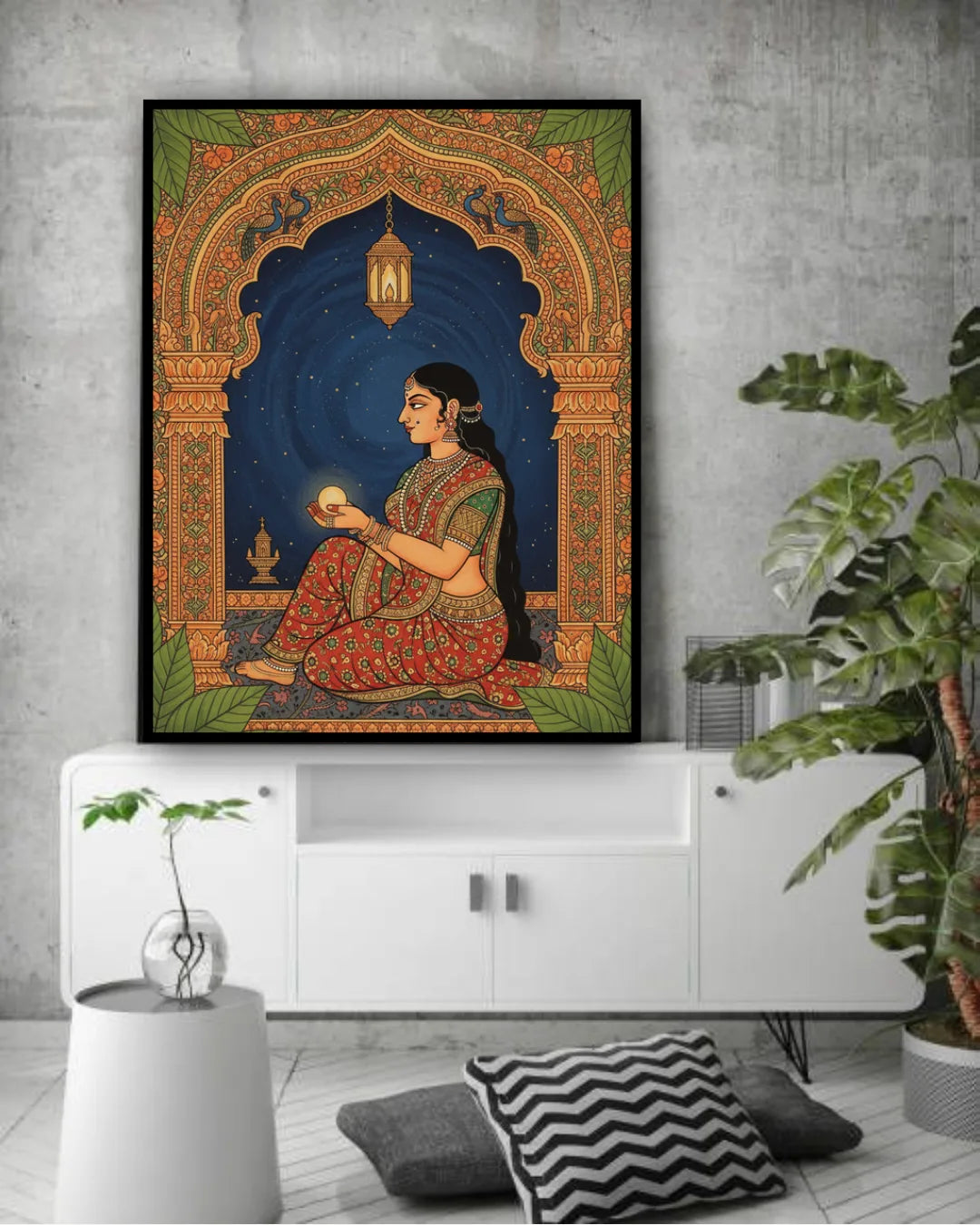 Framed artwork of a woman in traditional attire on a wall above a white cabinet.