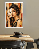 A framed art print depicting a woman holding a classical theater mask, displayed on a neutral wall above a wooden dining table with a black cup and saucer.