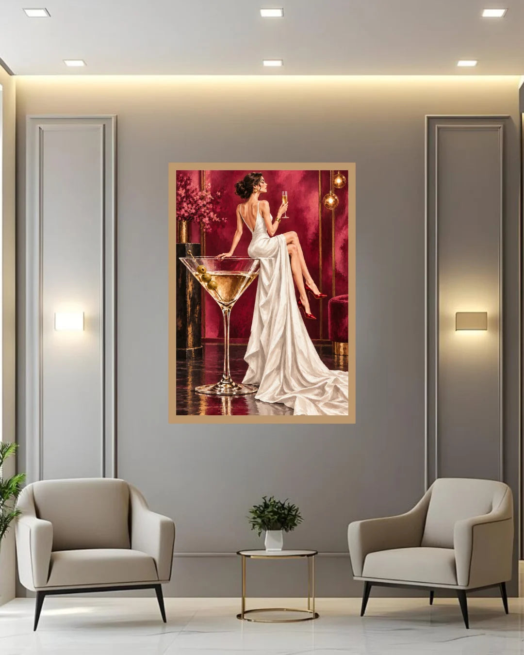 A framed art print depicting a woman in a white gown beside a martini glass, displayed on a gray wall in a modern living room setting with two beige armchairs and a small side table.