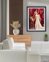 a woman in a white gown seated glass